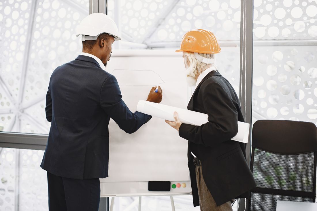 Two construction professionals reviewing a drawing together