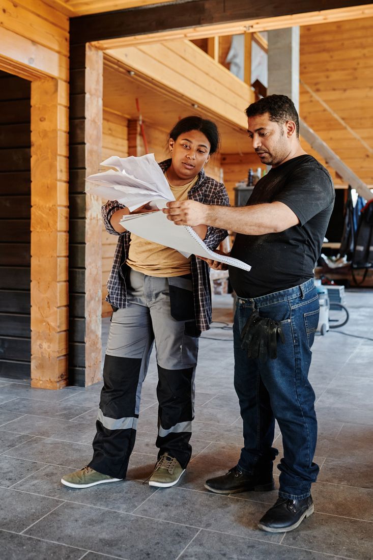 Two construction professionals reviewing documents on site